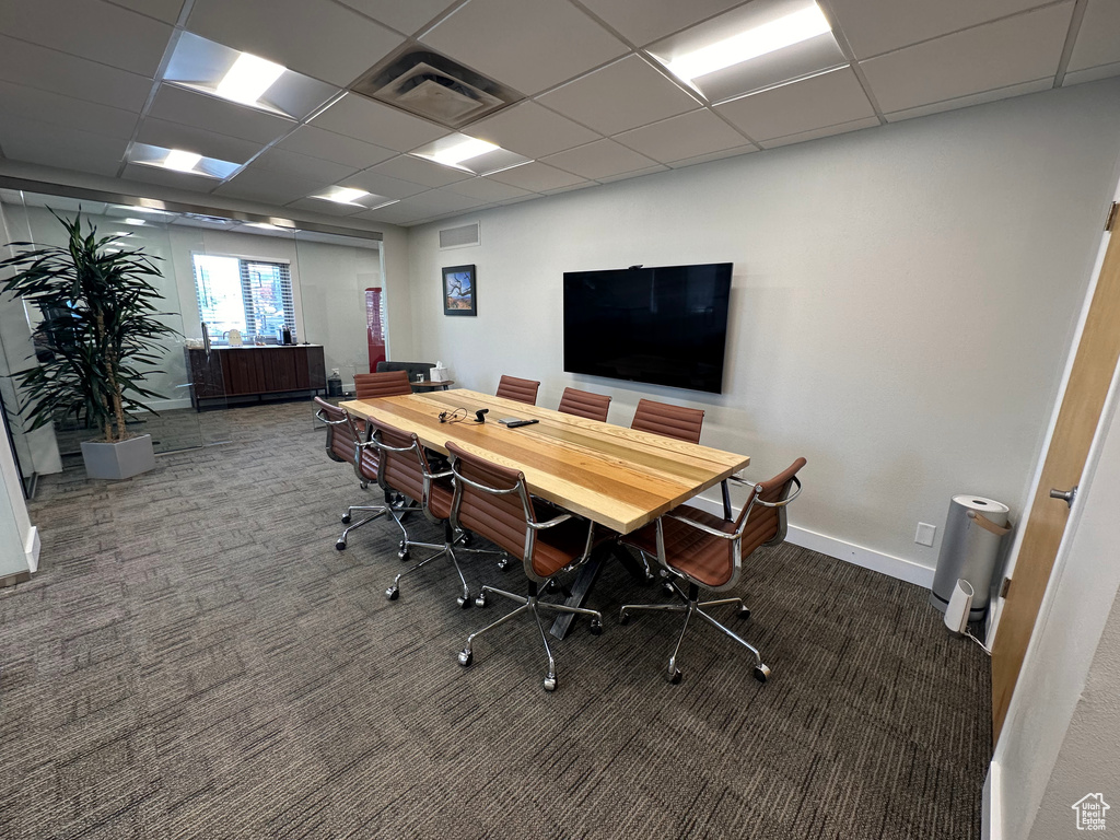 Office area with a paneled ceiling and carpet floors