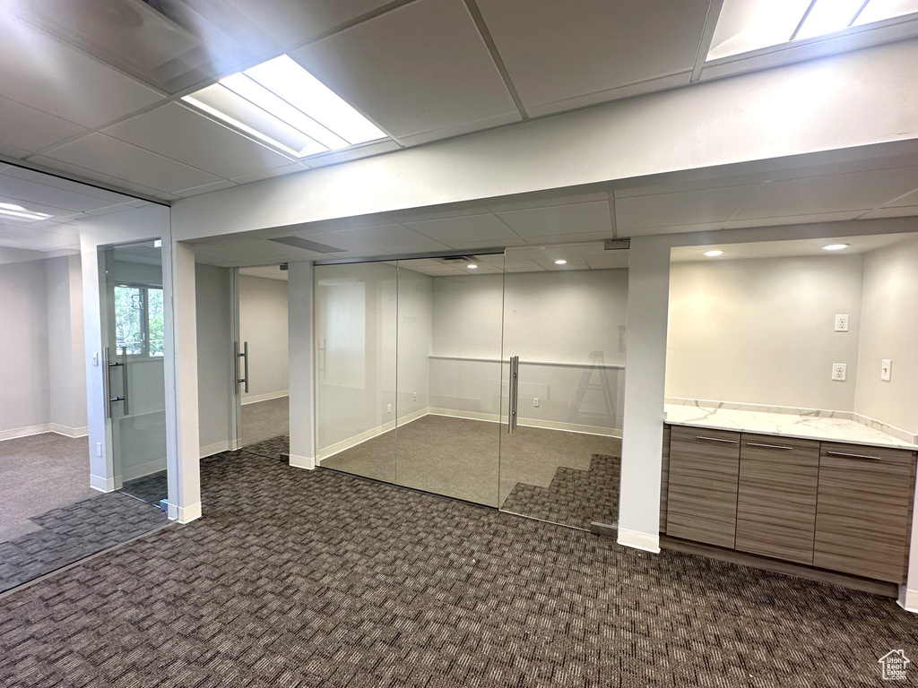 Basement with dark colored carpet