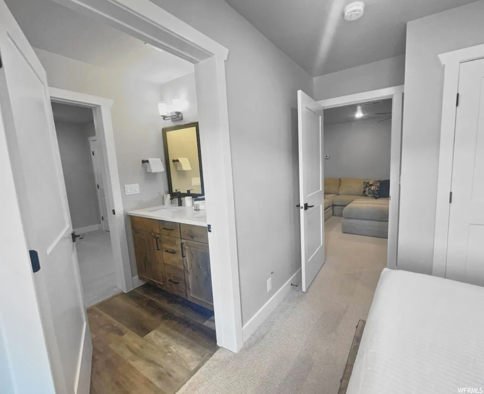Bathroom featuring light parquet floors, vanity, and mirror