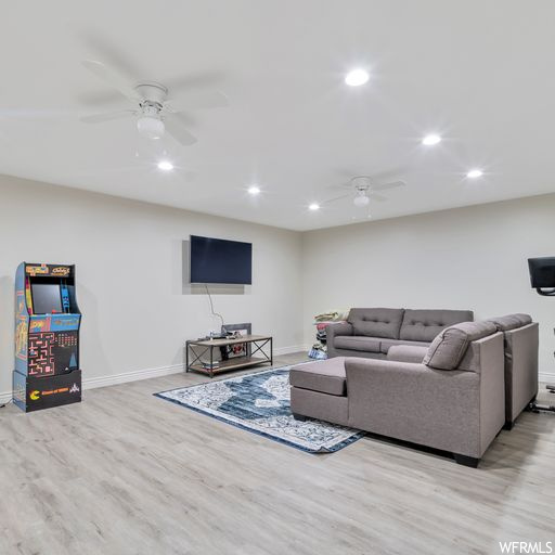 Living room featuring light parquet floors and ceiling fan