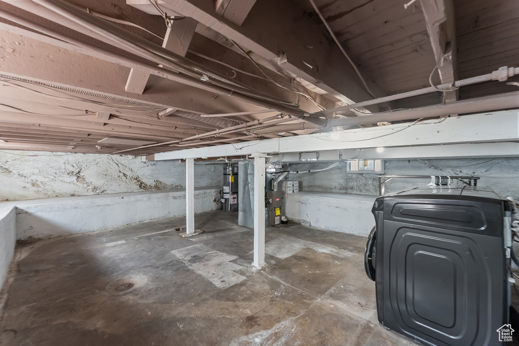 Basement featuring water heater and washer / clothes dryer