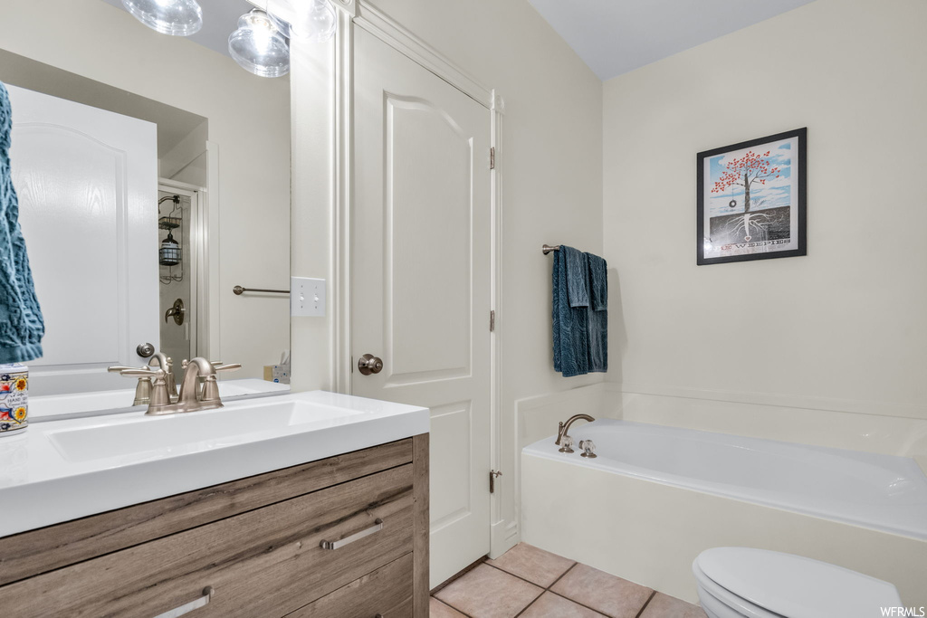 Bathroom featuring mirror, large vanity, a bath, and light tile floors