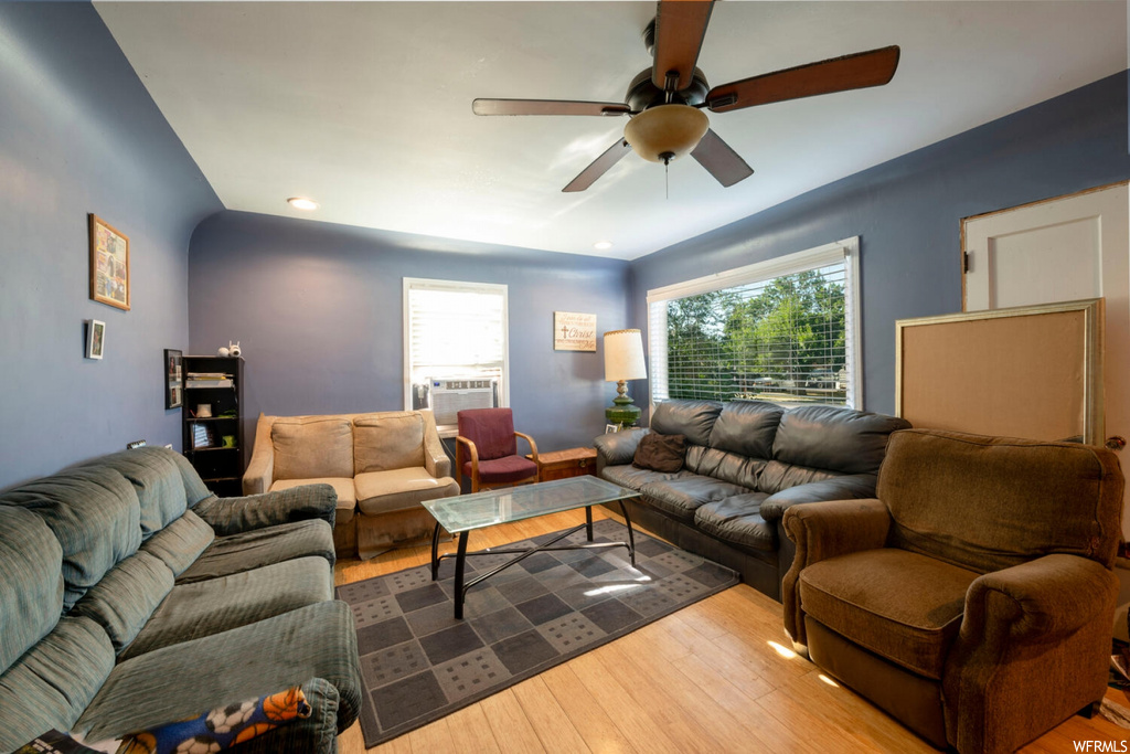 Living room featuring ceiling fan and light hardwood flooring