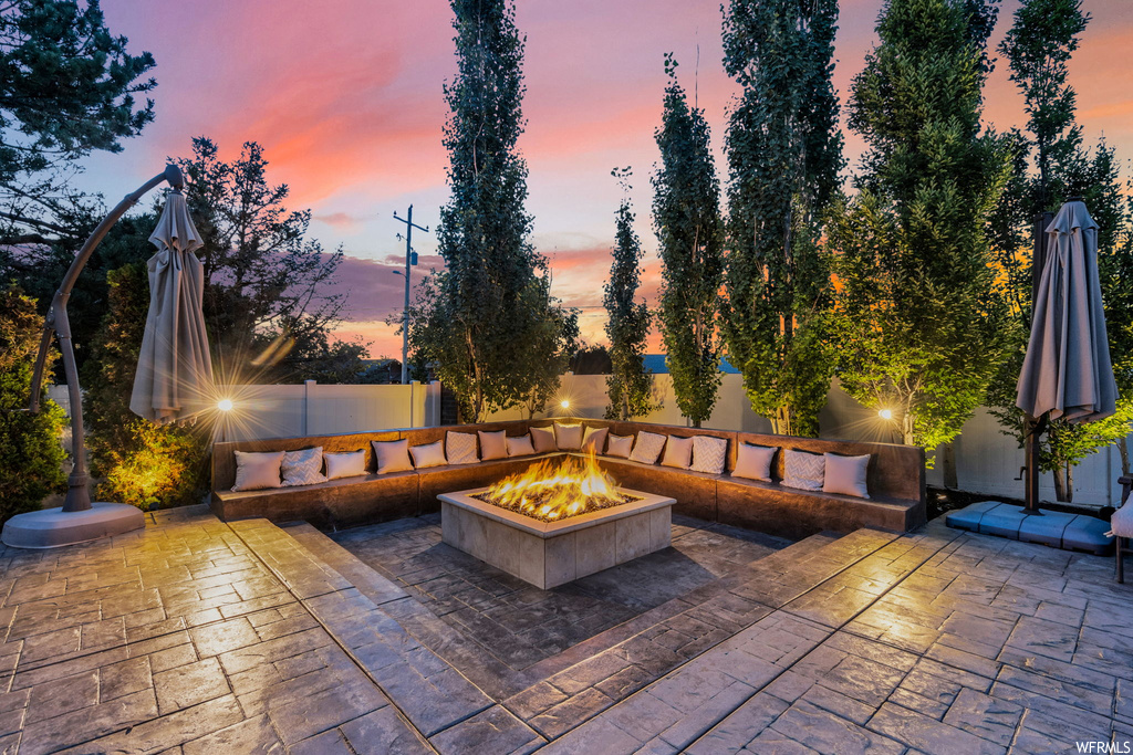 Patio terrace at dusk featuring a firepit