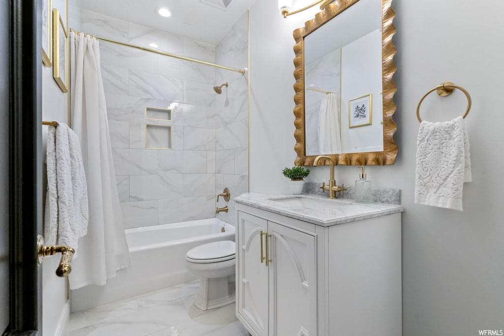 Full bathroom with shower / bath combo, vanity, mirror, and light tile floors