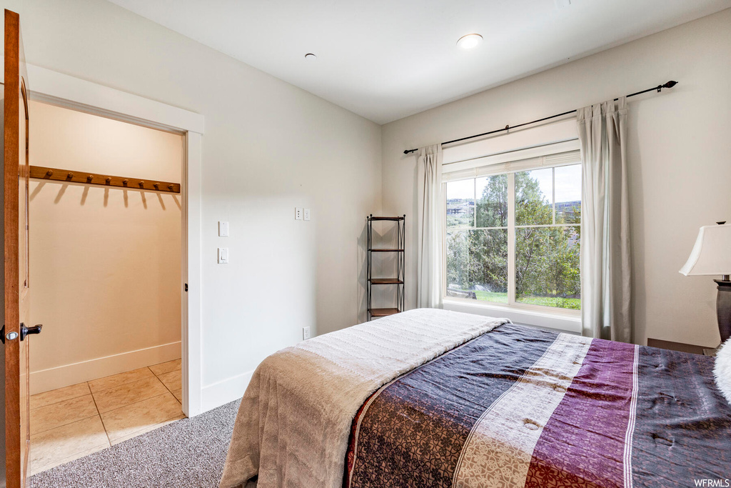 Bedroom with light tile flooring