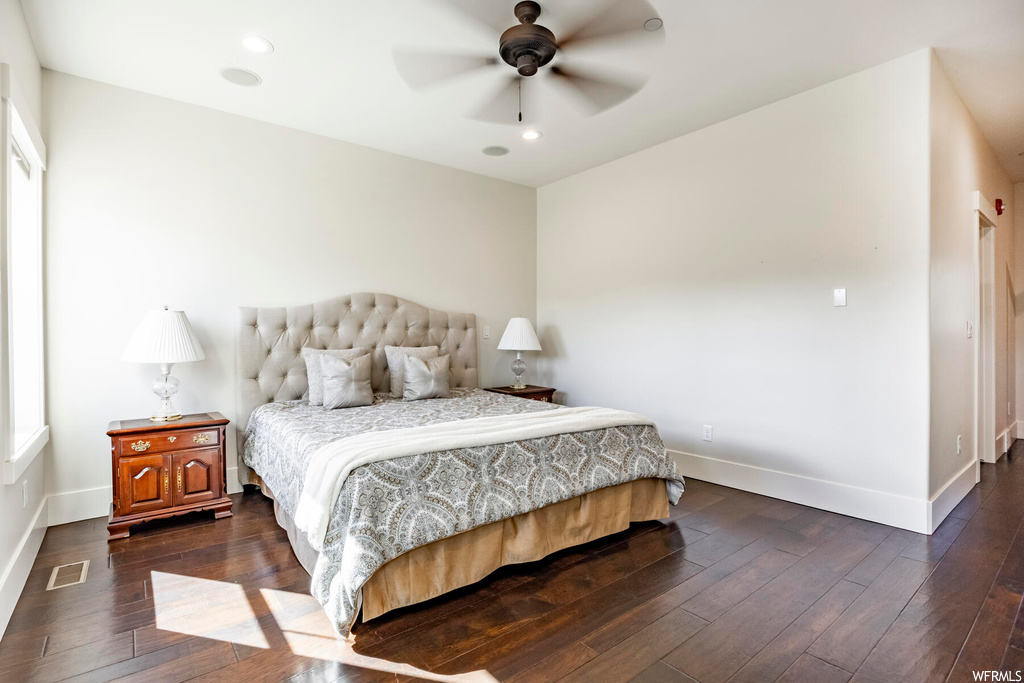 Bedroom with ceiling fan and dark hardwood flooring