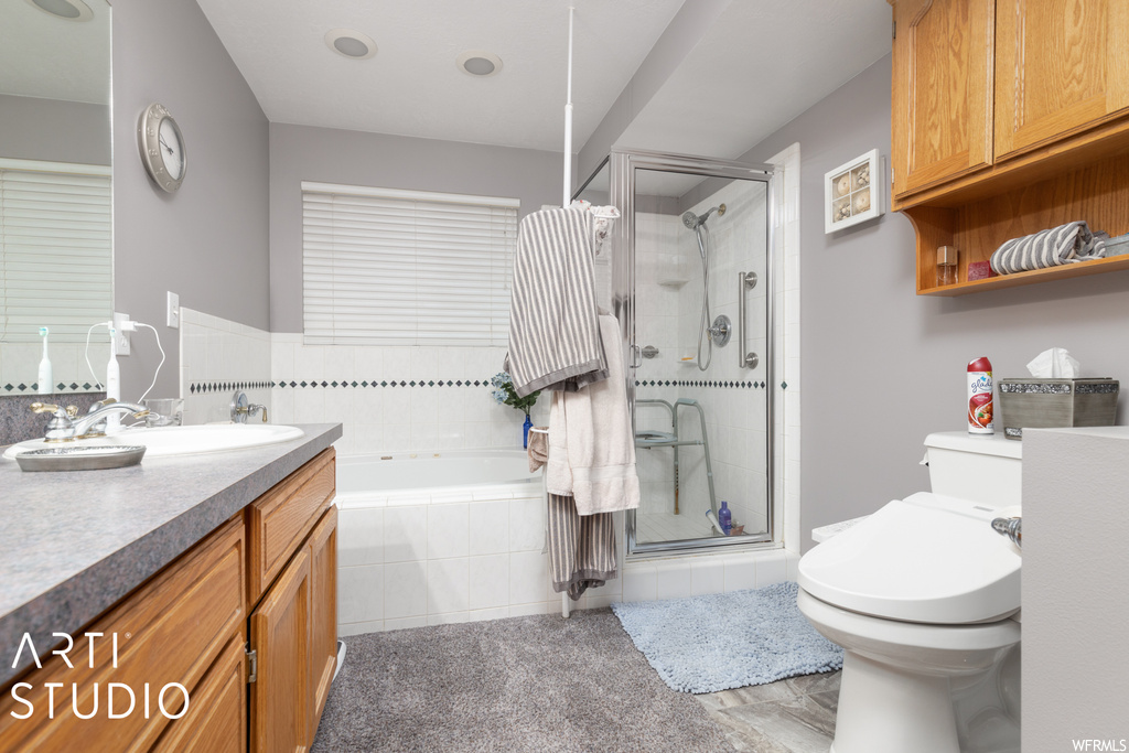 Full bathroom with mirror, vanity, and shower with separate bathtub
