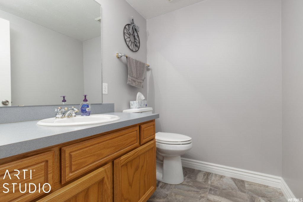 Bathroom featuring mirror, oversized vanity, and tile floors
