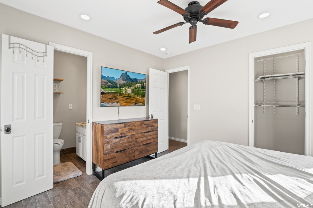 Hardwood floored bedroom with ceiling fan