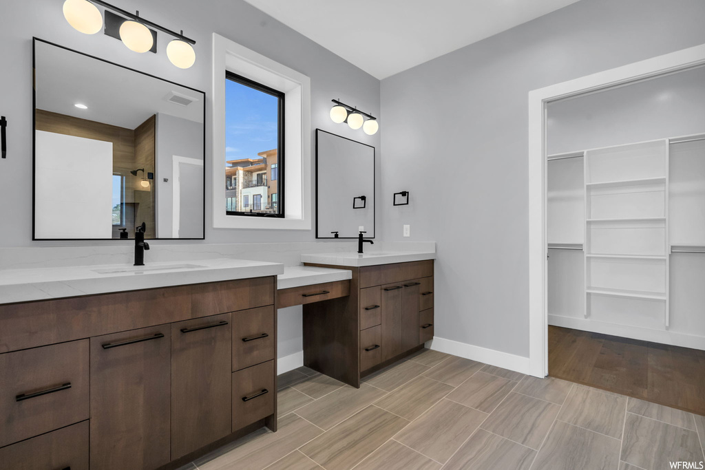 Bathroom with hardwood / wood-style flooring and dual bowl vanity