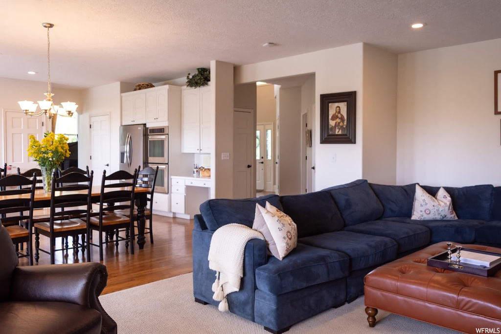 Living room with light hardwood floors and a textured ceiling