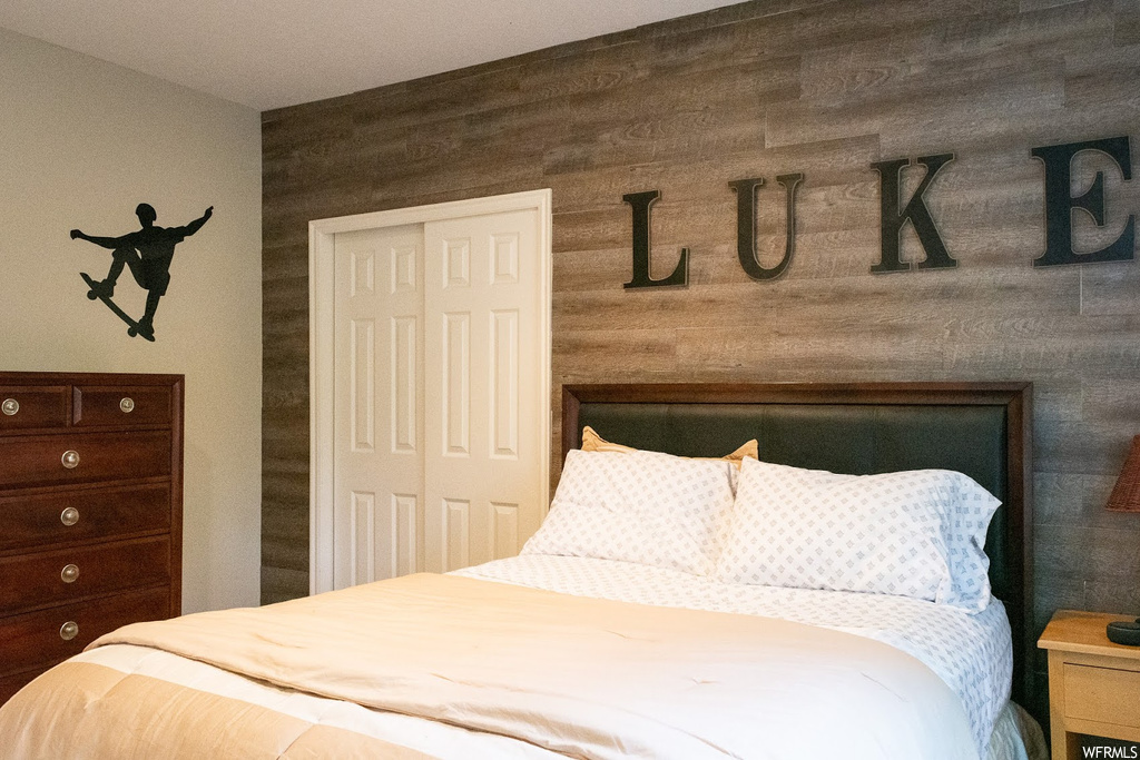 Bedroom with wood walls
