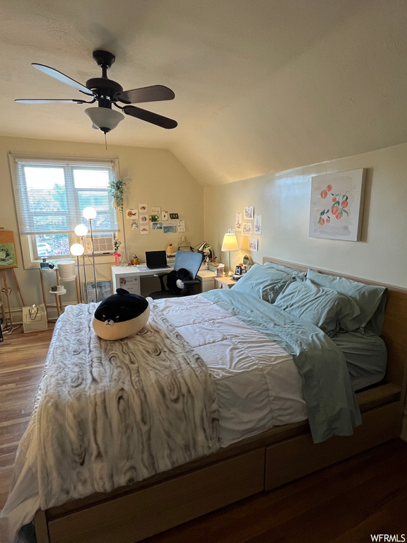 Bedroom with ceiling fan, lofted ceiling, and wood-type flooring