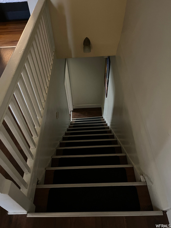 Stairs with dark parquet floors