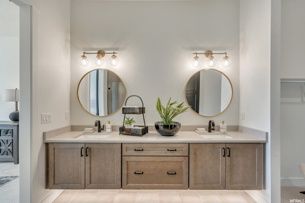 Bathroom featuring mirror and double large sink vanity