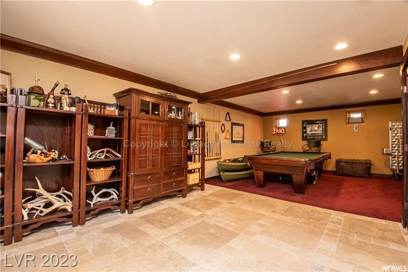 Game room with light tile floors and beam ceiling