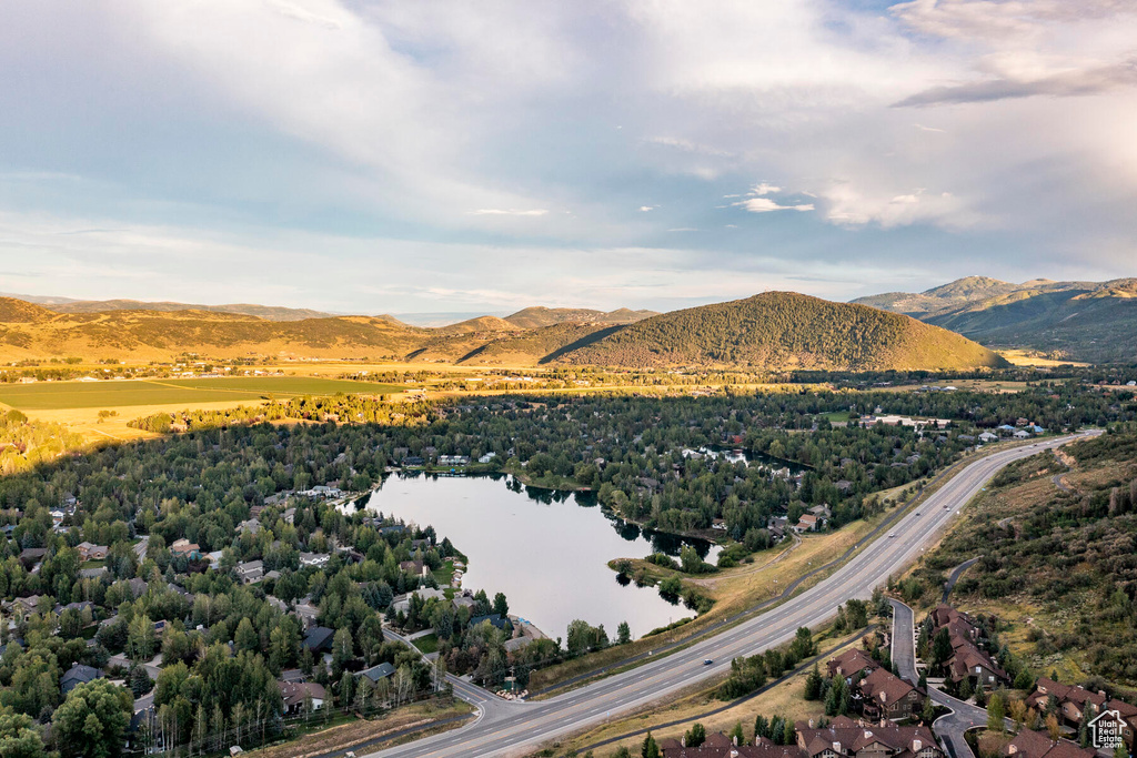 Drone / aerial view featuring a water and mountain view