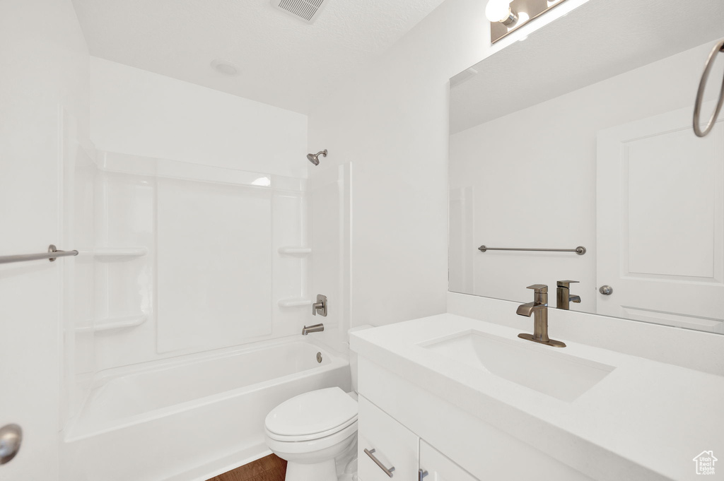 Full bathroom with vanity with extensive cabinet space, toilet, and bathing tub / shower combination