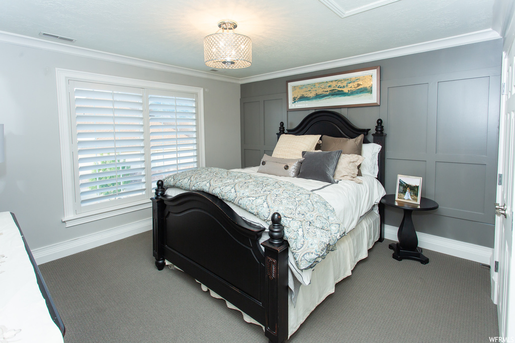 Bedroom featuring ornamental molding and carpet
