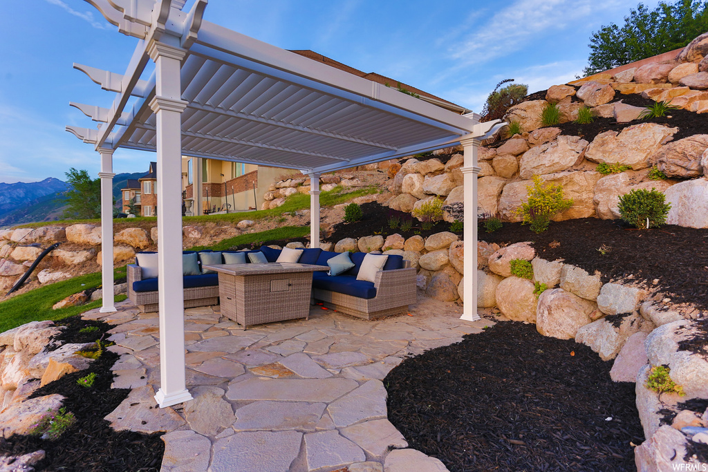View of patio / terrace with an outdoor living space, a mountain view, and a pergola