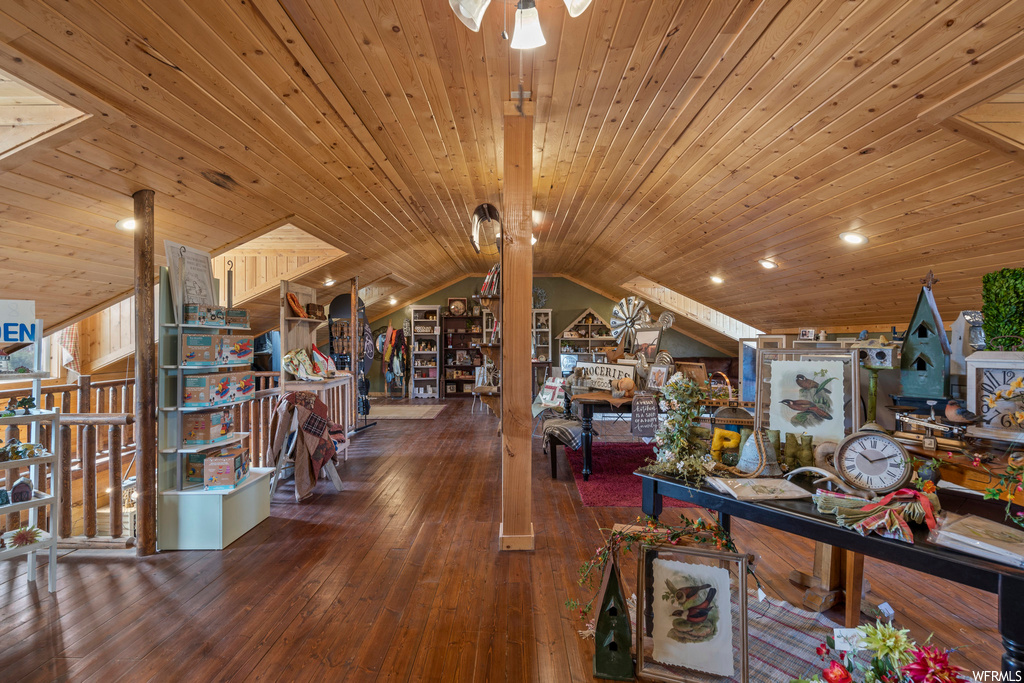 Interior space with vaulted ceiling, hardwood floors, and wood ceiling