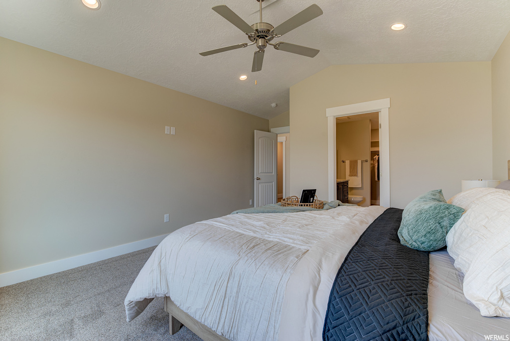 Bedroom with ceiling fan, light carpet, and lofted ceiling