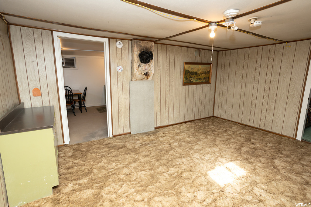 Carpeted empty room with wooden walls