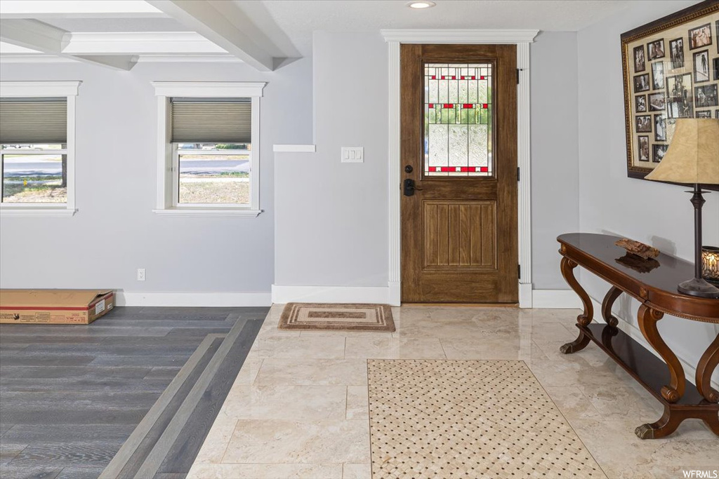 Tiled foyer entrance with beam ceiling