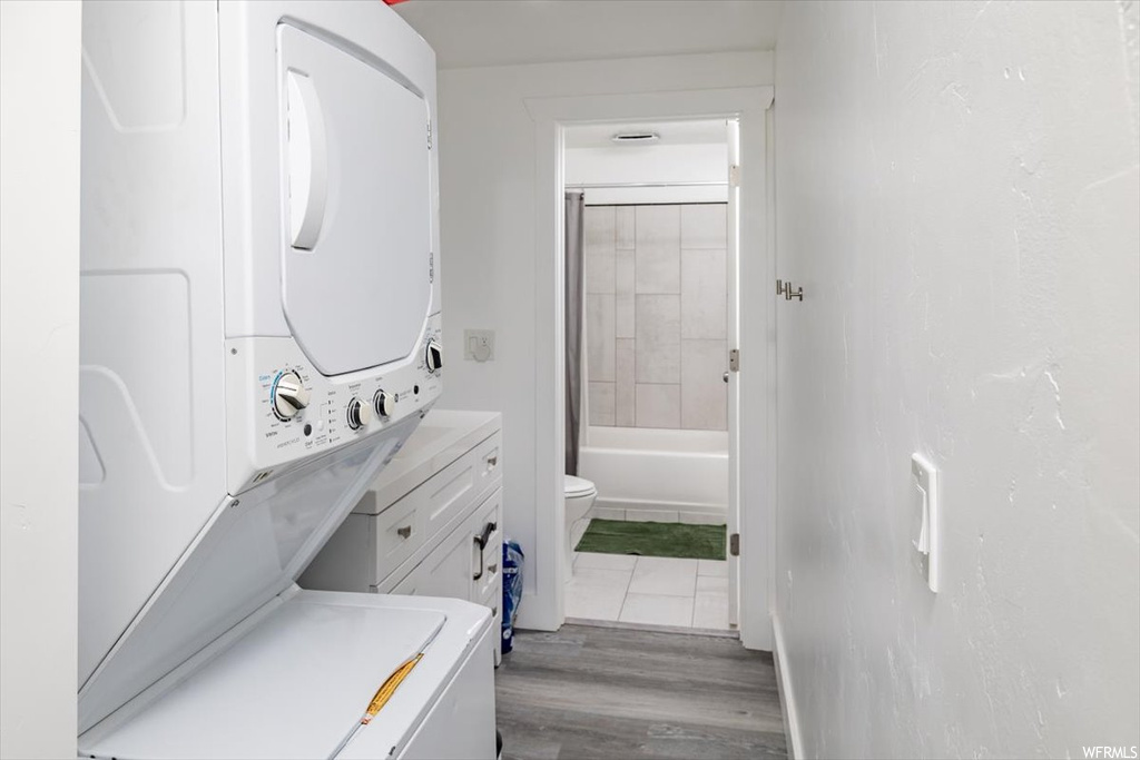 Washroom featuring washer / dryer and light hardwood floors