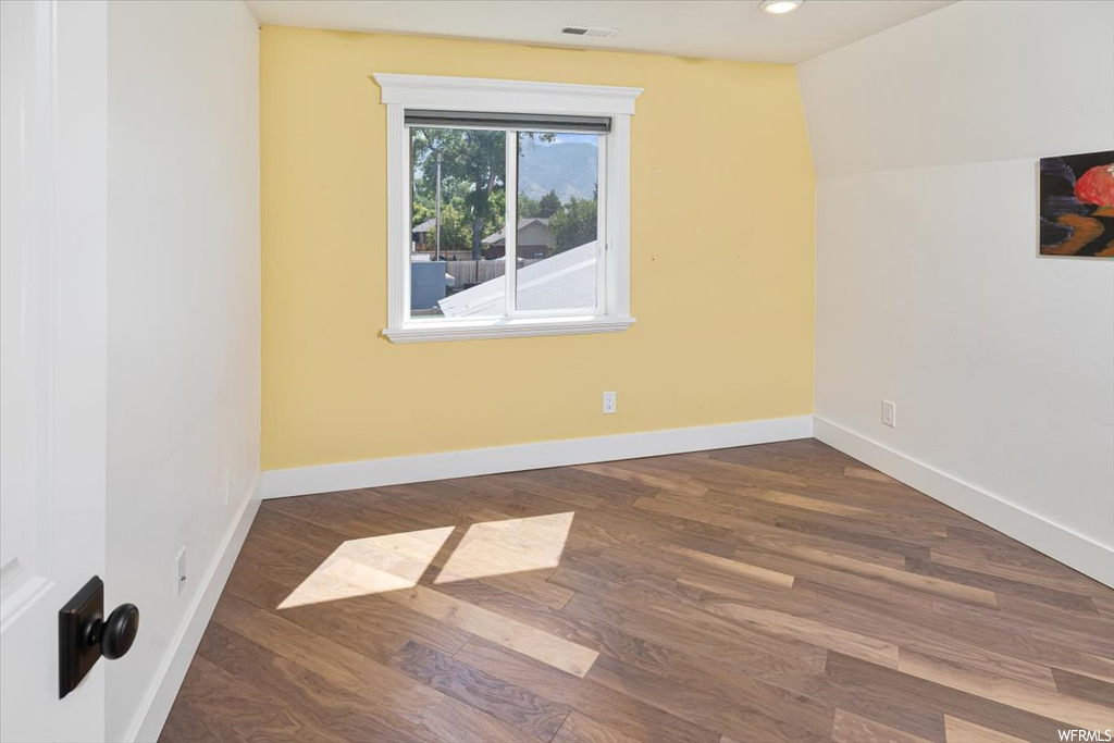 Spare room featuring hardwood flooring