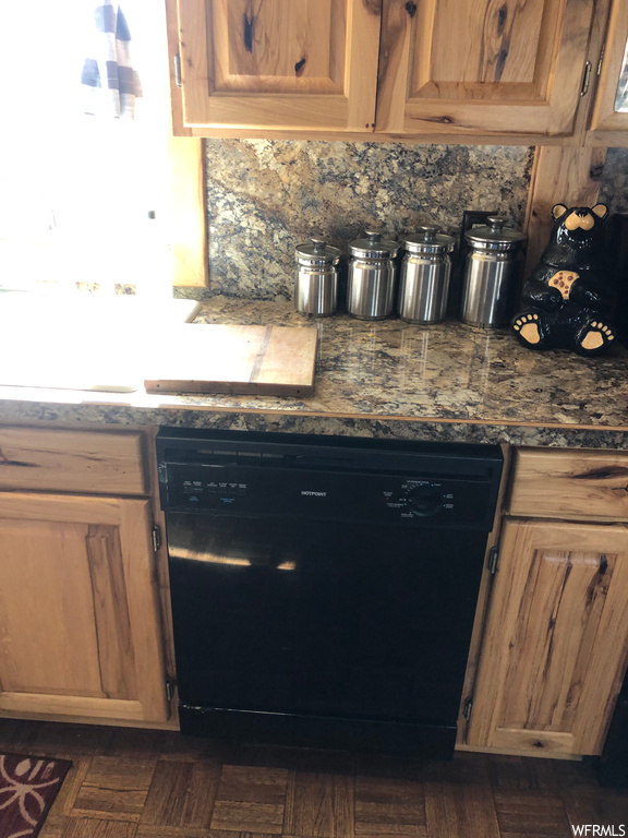 Kitchen with dark countertops and black dishwasher