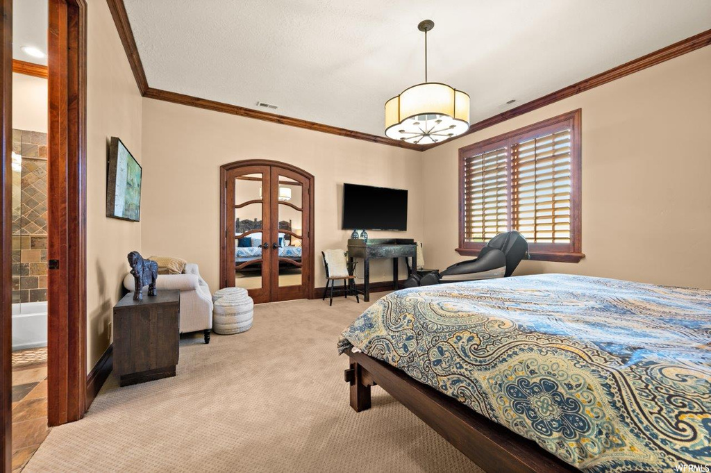 Carpeted bedroom featuring crown molding
