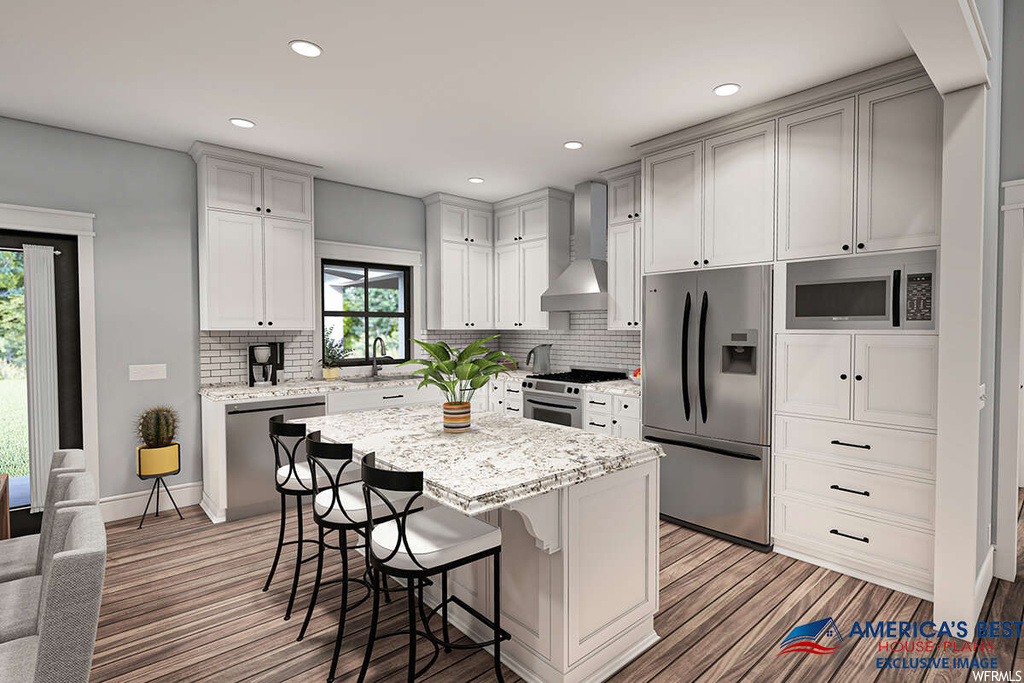 Kitchen featuring light parquet floors, stainless steel appliances, a kitchen island with sink, wall chimney exhaust hood, backsplash, white cabinetry, a center island, and light stone countertops