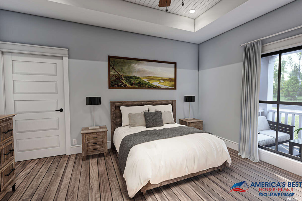 Bedroom with hardwood flooring and a raised ceiling