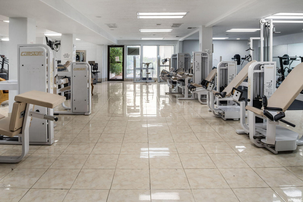Exercise room featuring light tile floors