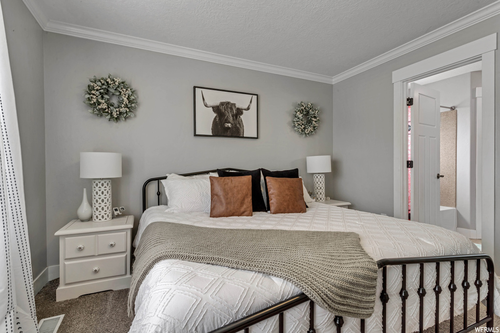 Bedroom featuring ornamental molding and light carpet