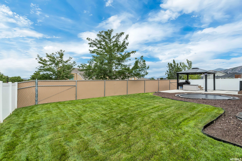 View of yard with a gazebo and a patio area