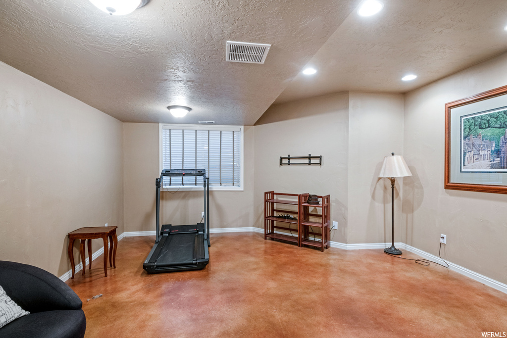Workout room with a textured ceiling
