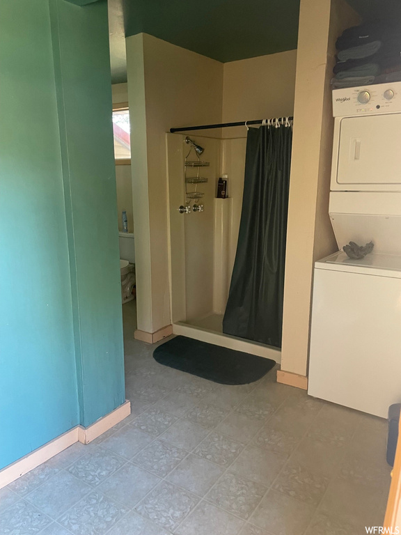 Bathroom featuring washer / dryer and light tile flooring