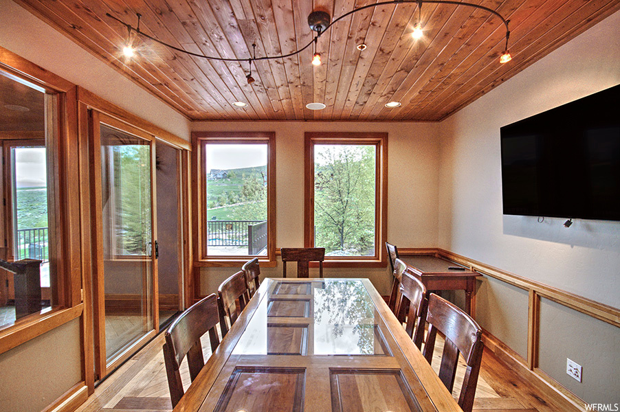 Hardwood floored dining room featuring wood ceiling