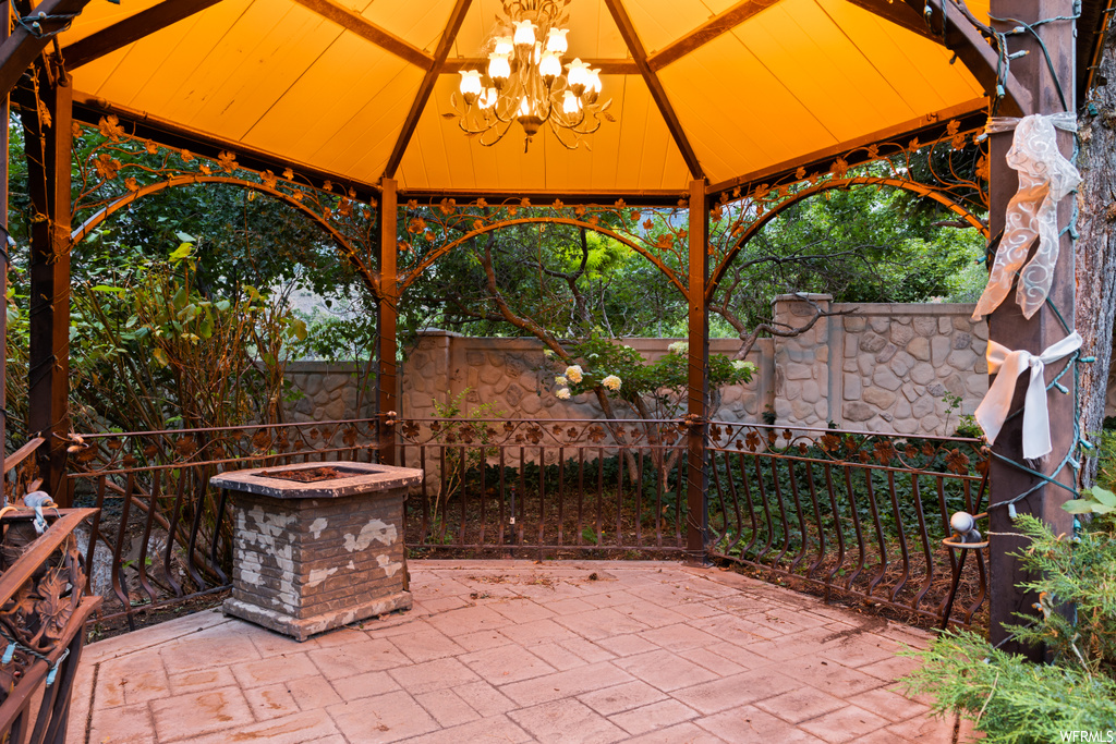 View of patio / terrace featuring an outdoor firepit and a gazebo