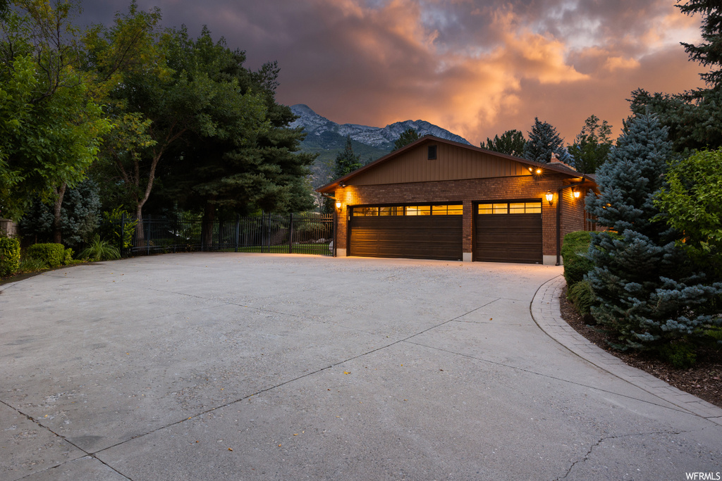 View of front of house featuring a mountain view and garage