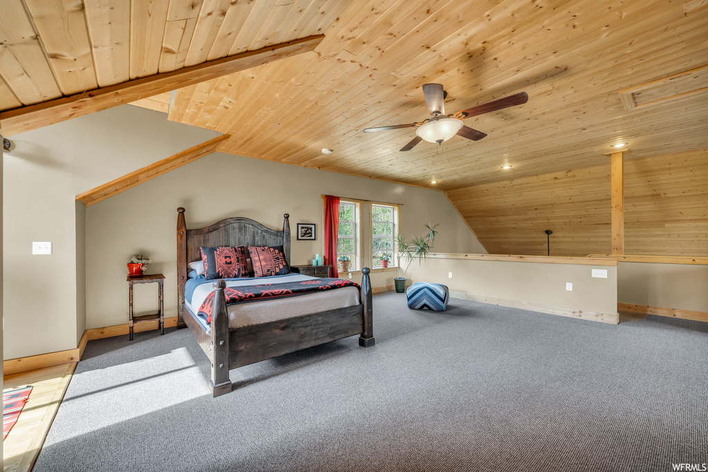Bedroom featuring vaulted ceiling, light carpet, ceiling fan, and wooden ceiling