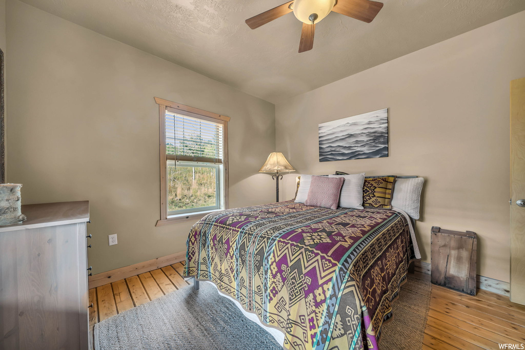 Bedroom featuring light hardwood flooring and ceiling fan