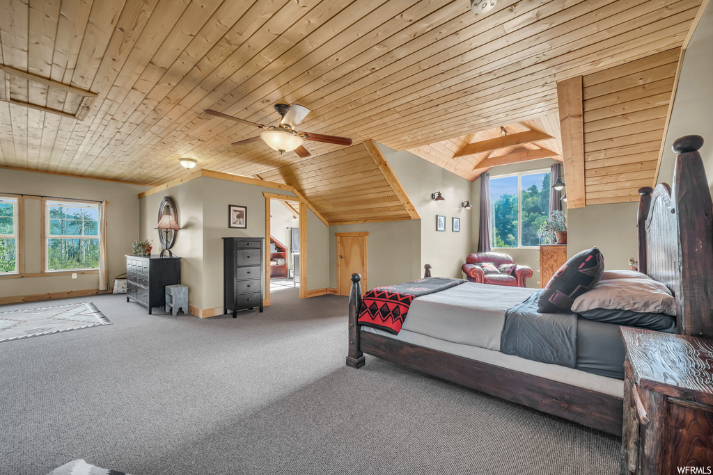 Bedroom featuring multiple windows, light carpet, wood ceiling, vaulted ceiling, and ceiling fan