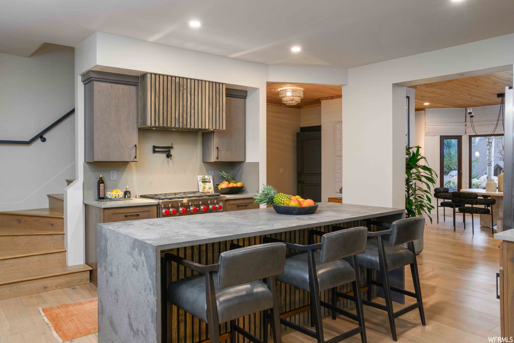 Kitchen featuring light parquet floors, light countertops, and stainless steel gas stovetop