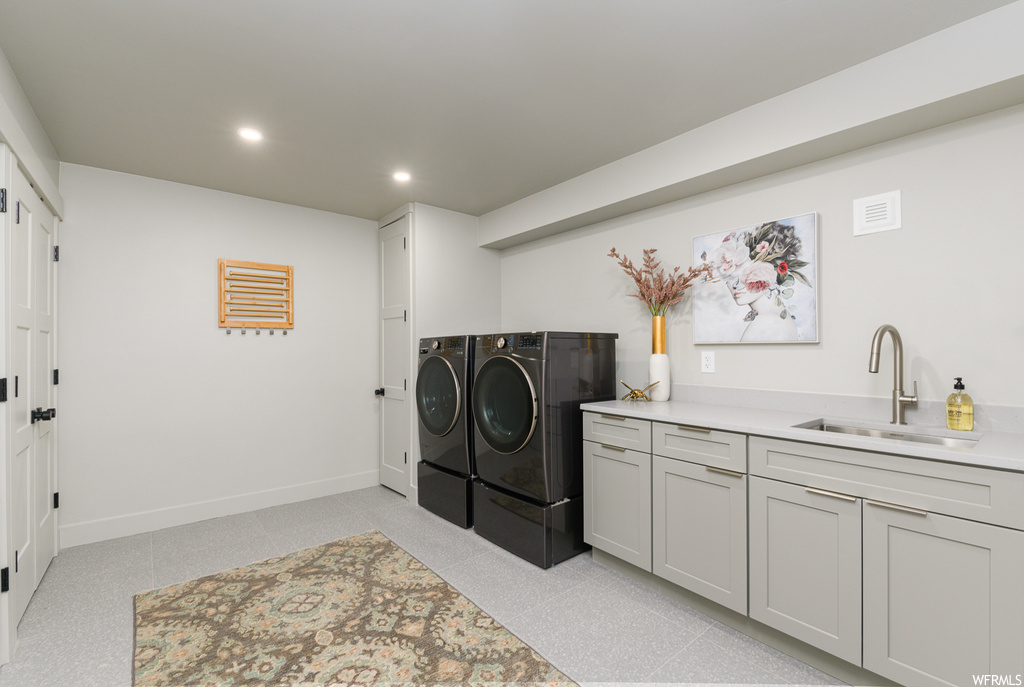 Washroom featuring washer / clothes dryer and light tile flooring