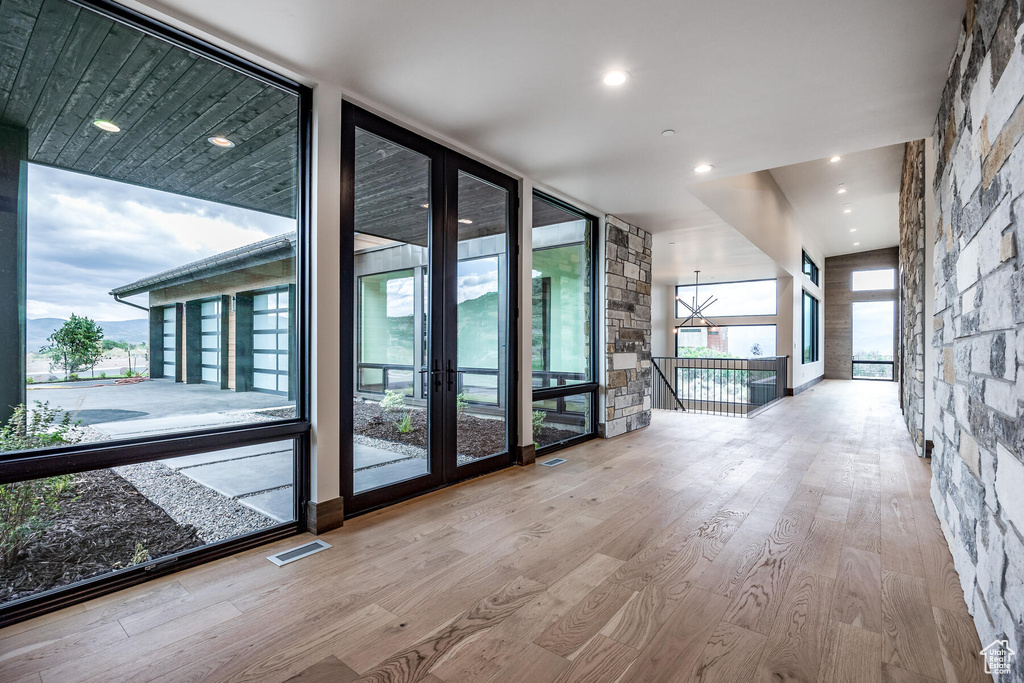 Interior space with light wood-type flooring and a wall of windows