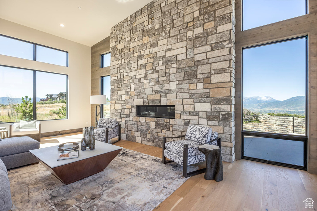 Living room with a fireplace, light hardwood / wood-style floors, and a mountain view